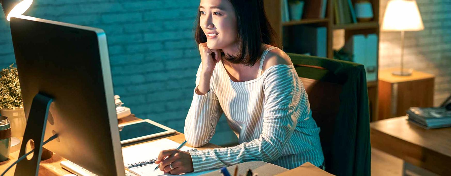 A writer working at a desk with focused attention on the page